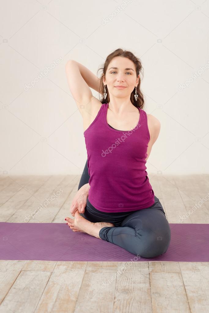 Young woman doing yoga exercises