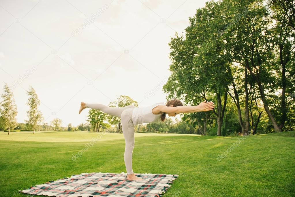 Woman doing yoga exercises outdoor