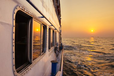 Beautiful sunset from ferry boat in open sea clipart