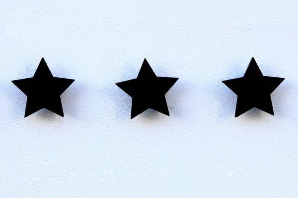Three stars on a white facade - three stars hotel