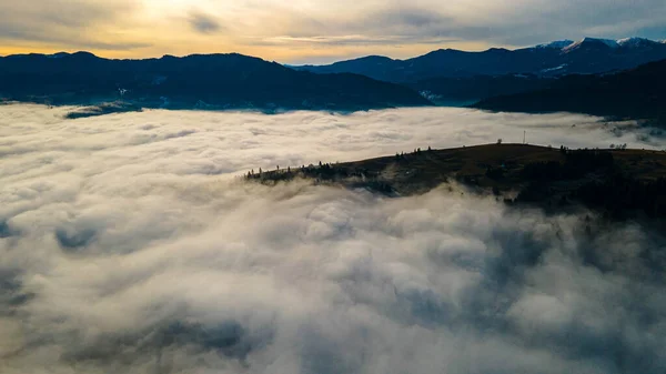 mountains tops high above clouds fog