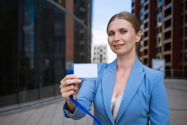 Business woman holding badge in hand