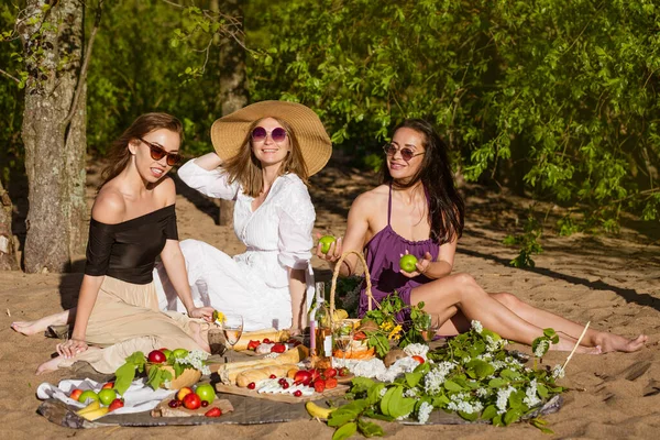 Girlfriends celebrate in the summer at a picnic. Beautiful