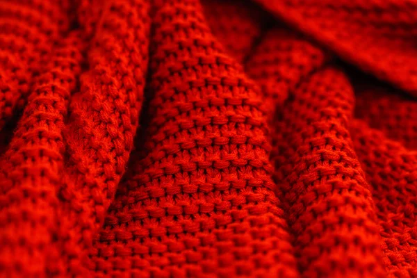 Texture of red knitted fabric close up. Wool jersey.