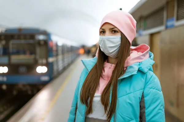 woman on the subway wearing a protective mask