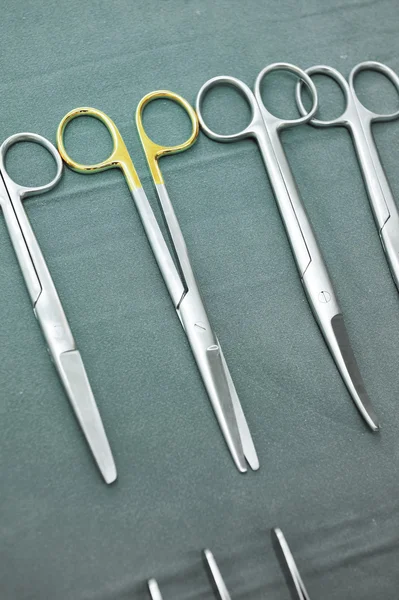 Detail shot of steralized surgery instruments with a hand grabbing a tool — Stock Photo, Image