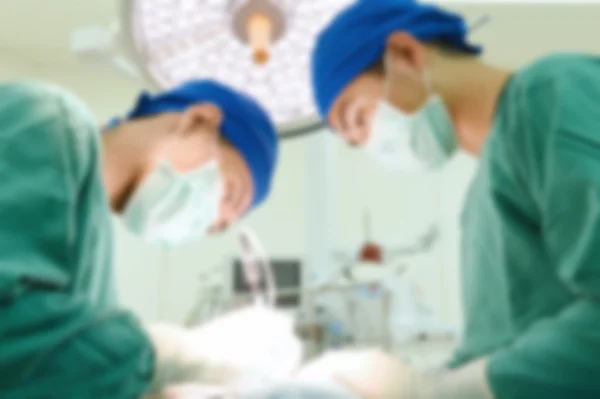 Blur of two veterinarian surgeons in operating room — Stock Photo, Image