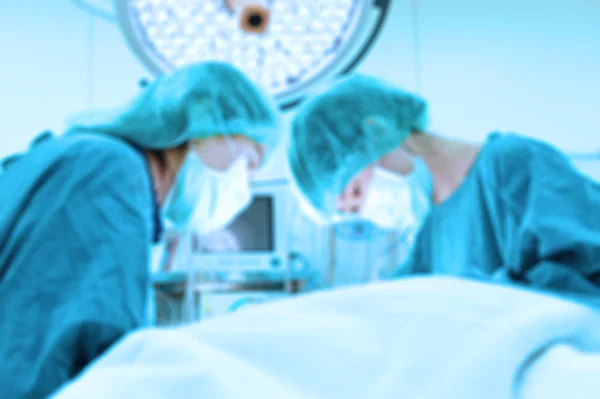 Blur of two veterinarian surgeons in operating room — Stock Photo, Image