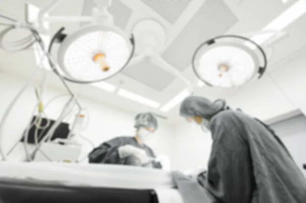 Blur of two veterinarian surgeons in operating room — Stock Photo, Image