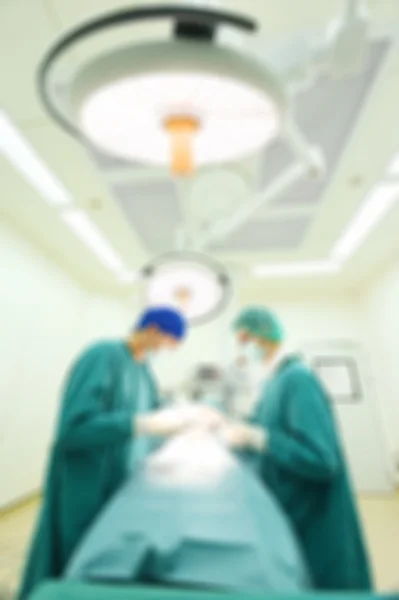 Blur of two veterinarian surgeons in operating room — Stock Photo, Image