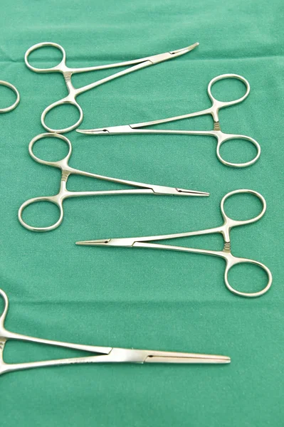 Detail shot of steralized surgery instruments with a hand grabbing a tool — Stock Photo, Image