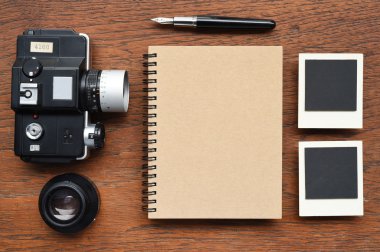 Defter kalem, fotoğraf çerçeveleri ve kamera ile 