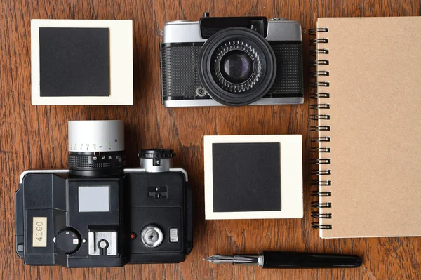 Blank notebook with pen, photo frames and camera — Stock Photo, Image