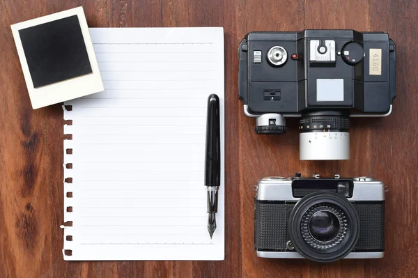 Blank paper with pen, photo frames and camera — Stock Photo, Image