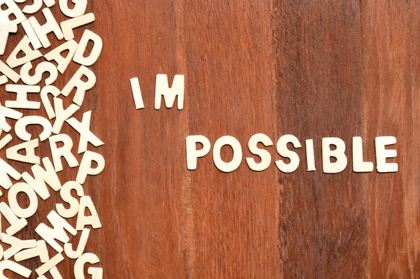 Word impossible made with block wooden letters — Stock Photo, Image