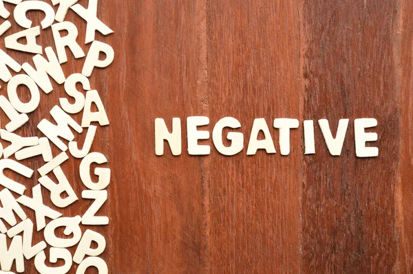 Word negative made with block wooden letters — Stock Photo, Image