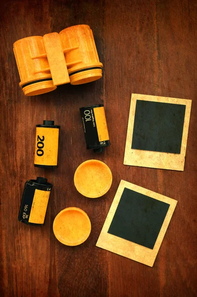 Photo film with photo frames on wooden background — Stock Photo, Image