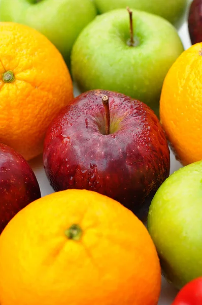 close up of fresh mixed fruits red apple and orange with green apple on background fruit health food