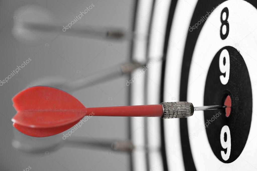 Dartboard with red darts