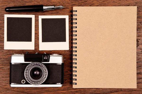 Notizbuch mit Stift, Fotorahmen und Kamera — Stockfoto