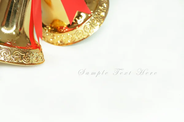 Golden bells with a red bow — Stock Photo, Image