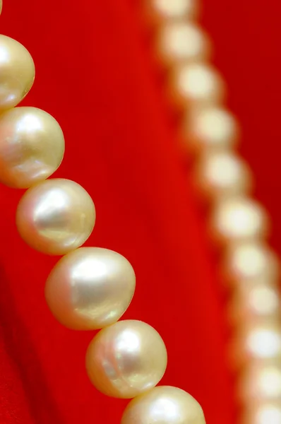 Pearl necklace on luxury red background — Stock Photo, Image