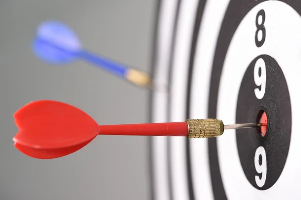 Dartboard with darts on gray background — Stock Photo, Image