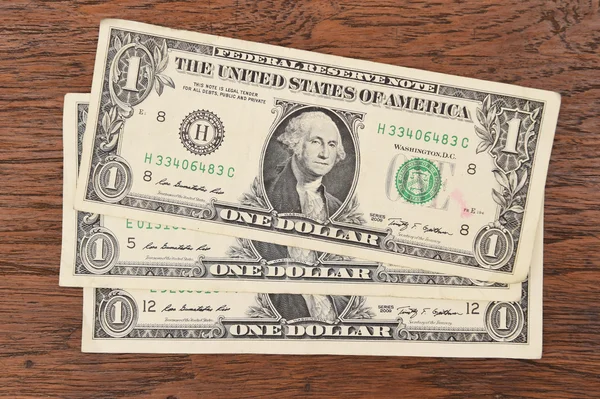 Jeden dolar na hnědé pozadí. — Stock fotografie