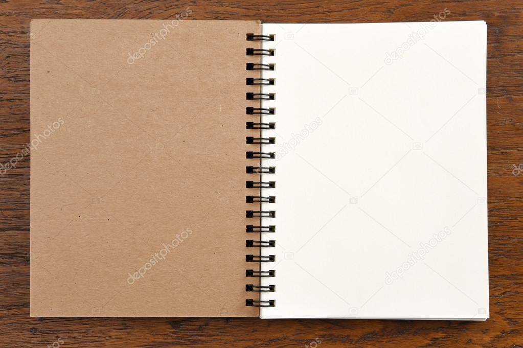 Open notebook on wooden background