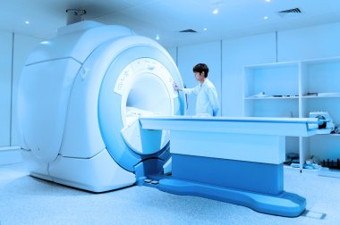 Veterinarian doctor working in MRI scanner room clipart