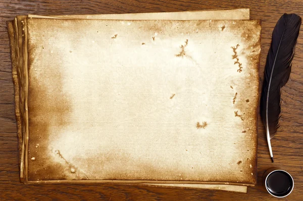 Old paper on brown wood texture with feather and ink — Stock Photo, Image
