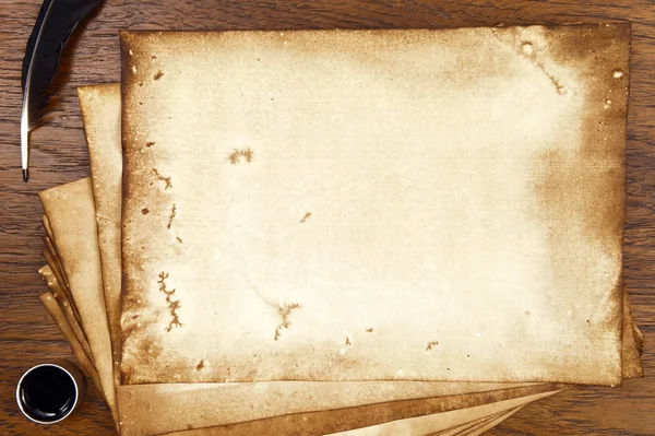 Old paper on brown wood texture with feather and ink — Stock Photo, Image