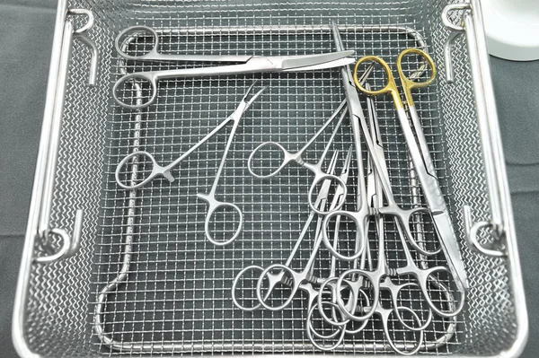 Detail shot of steralized surgery instruments with a hand grabbing a tool — Stock Photo, Image