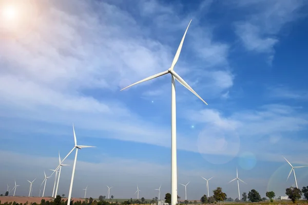 Wind turbine against cloudy blue sky background — Stock Photo, Image