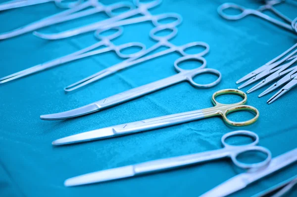 Detail shot of steralized surgery instruments with a hand grabbing a tool — Stock Photo, Image