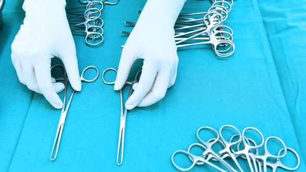 Detail shot of steralized surgery instruments with a hand grabbing a tool — Stock Photo, Image