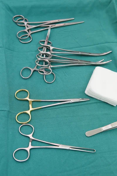 Detail shot of steralized surgery instruments with a hand grabbing a tool — Stock Photo, Image