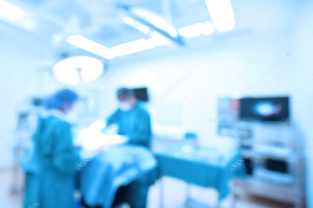 Blur of two veterinarian surgeons in operating room