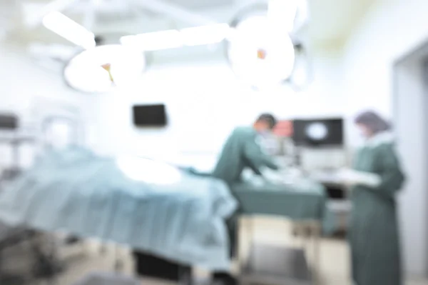 Blur of two veterinarian surgeons in operating room take with selective color technique and art lighting — Stock Photo, Image