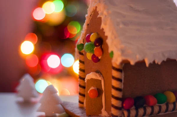 Gingerbread house on the background of Christmas lights — Stock Photo, Image