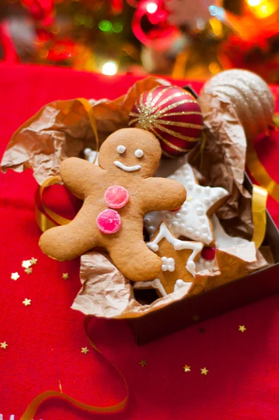 Noel ağacının arka planında hediye kutusundaki kurabiyeler