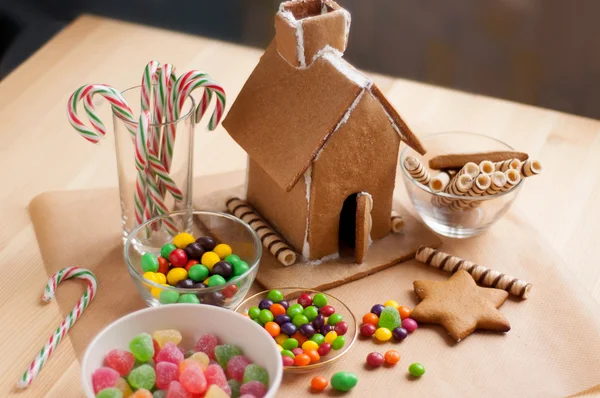 Decorating a gingerbread house Stock Photo