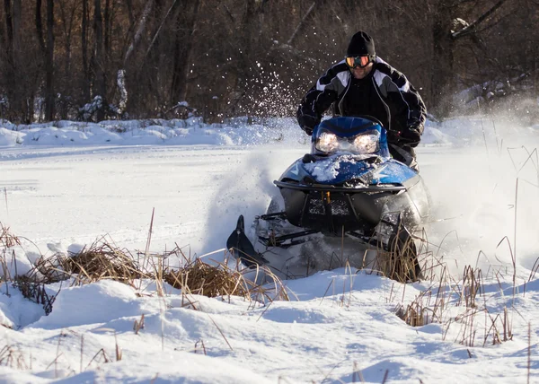 Snowmobile driving Stock Image