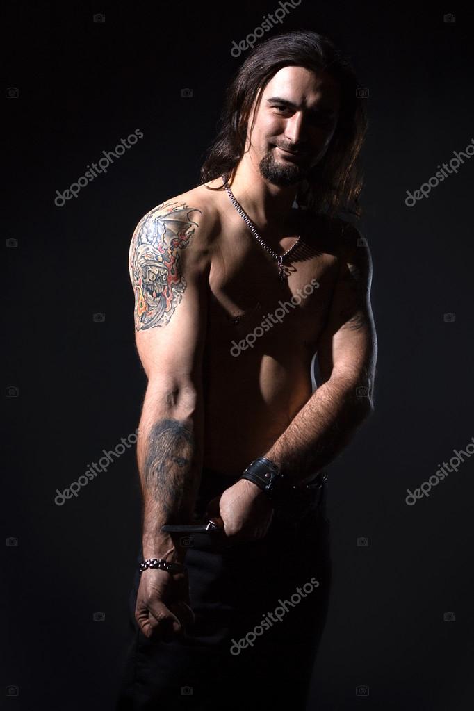 Introverted Long Haired Man With Tattoos by Stocksy Contributor Kkgas   Stocksy