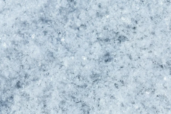 Die Textur der Schneeoberfläche Nahaufnahme. Stockfoto
