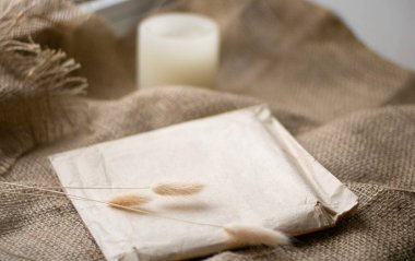 Yerleşim planı. Masanın üzerinde pastel renkli zarflarla mumlar. Yan görünüş. Çuval bezi.