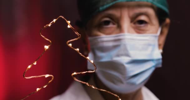 Woman Doctor Holding Christmas Tree Shaped Garland Hand — Stock Video