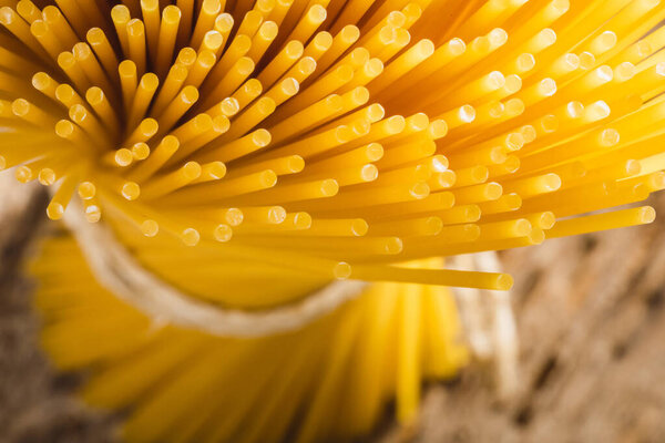 close up of yellow long spaghetti. Yellow italian pasta. Raw spaghetti. Food background concept.