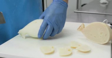 Süt ürünlerinde mozzarella peyniri yapan adamın yakın çekim görüntüleri.