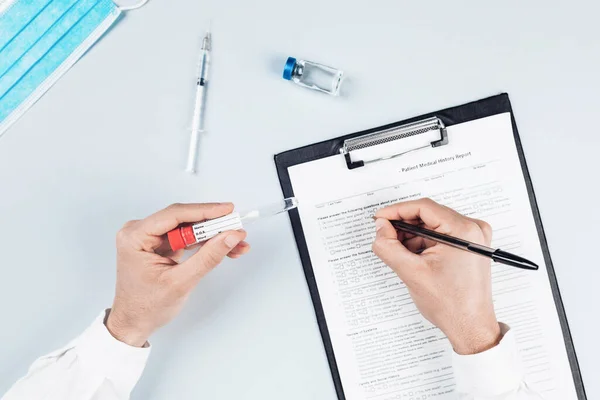 Erkek doktorların kesilmiş kısımları ellerinde tıbbi malzemelerle masada.